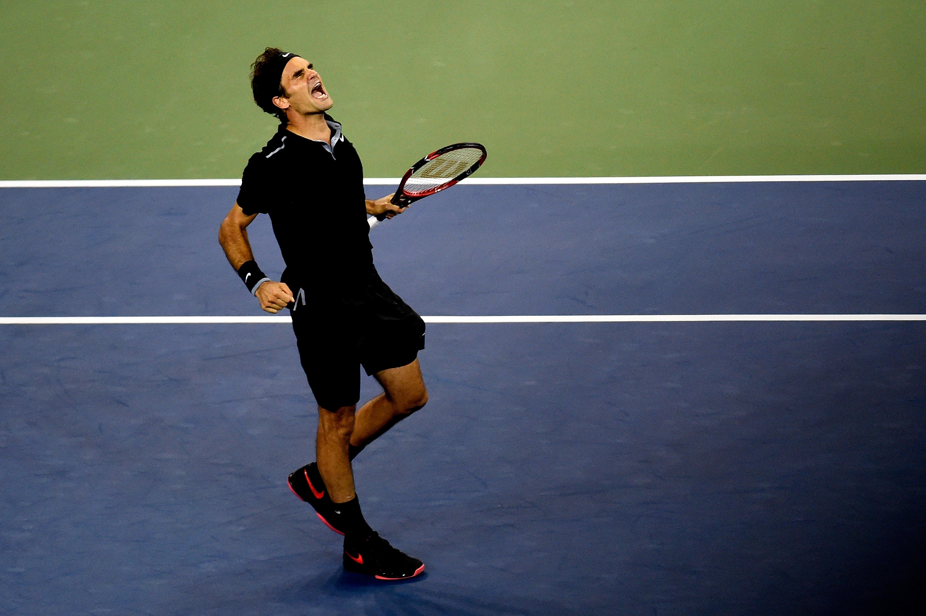 Federer rallies from two sets down to stun Monfils 